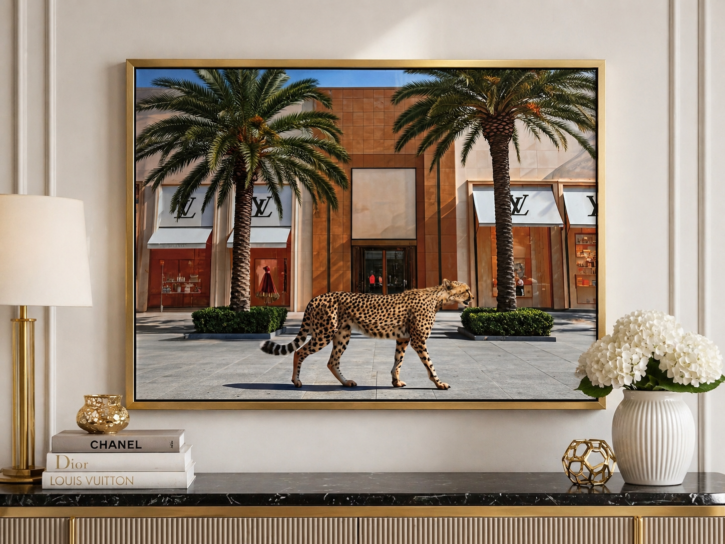 Framed artwork of a leopard walking in front of a building with palm trees, displayed on a wall above a console table.